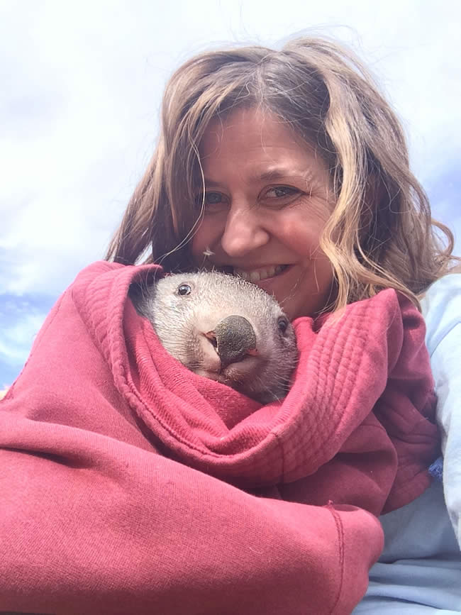Kama with a bundled-up wombat named Cruiser